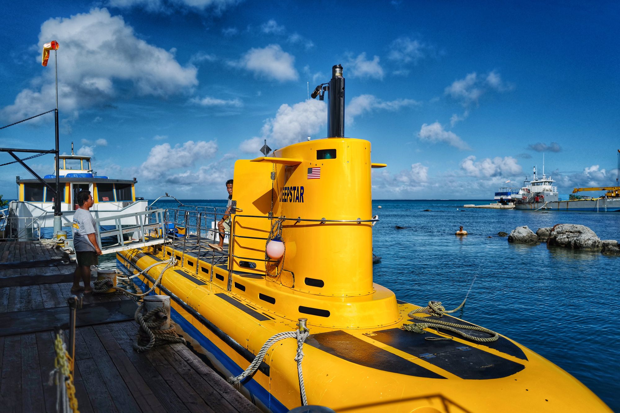 Yellow submarine docked above water.