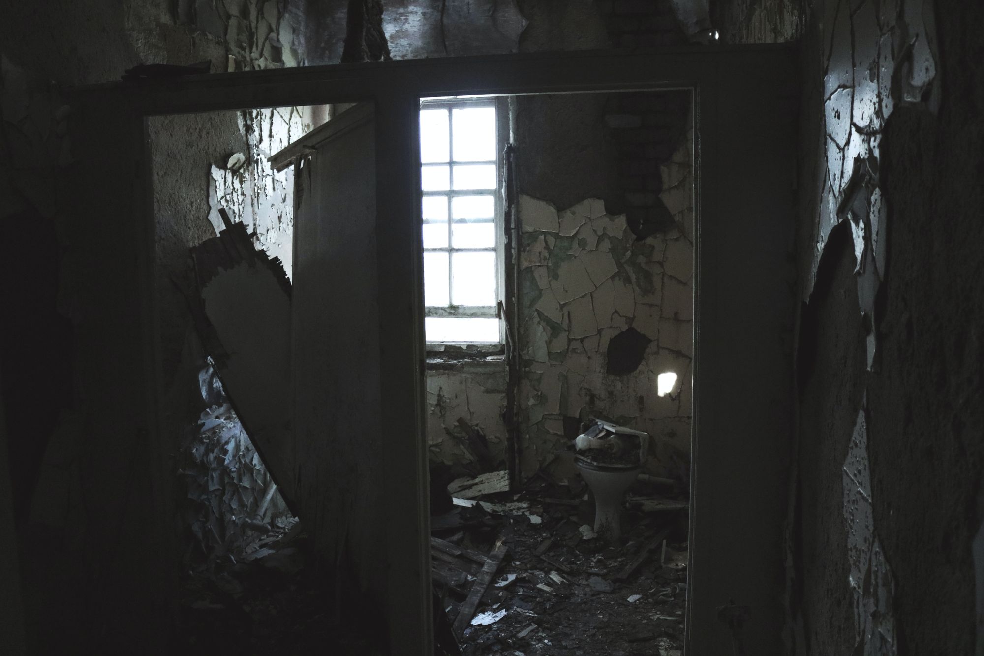 Bathroom in an old building that's falling apart.