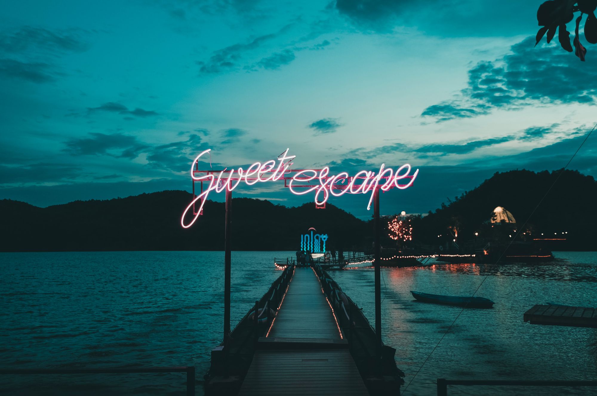 Dock over water with LED sign that reads "Sweet Escape".