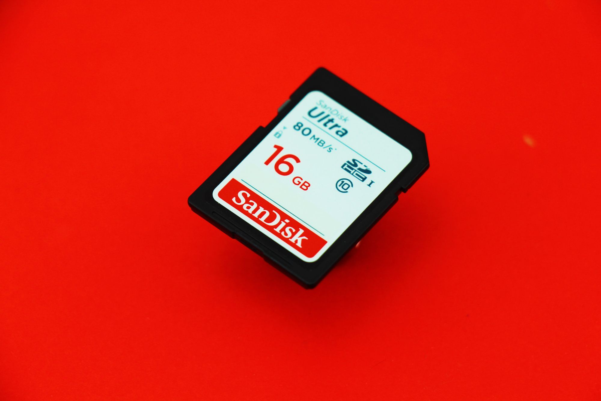 16GB SD card on a red background.