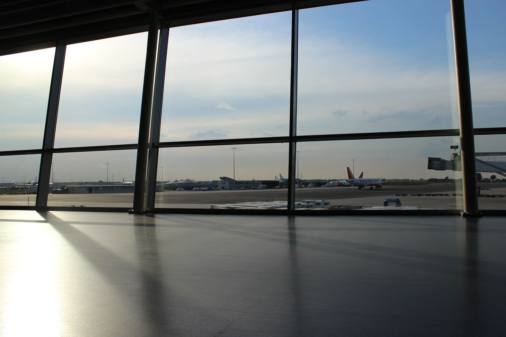 Empty terminal with planes parked outside the windows.