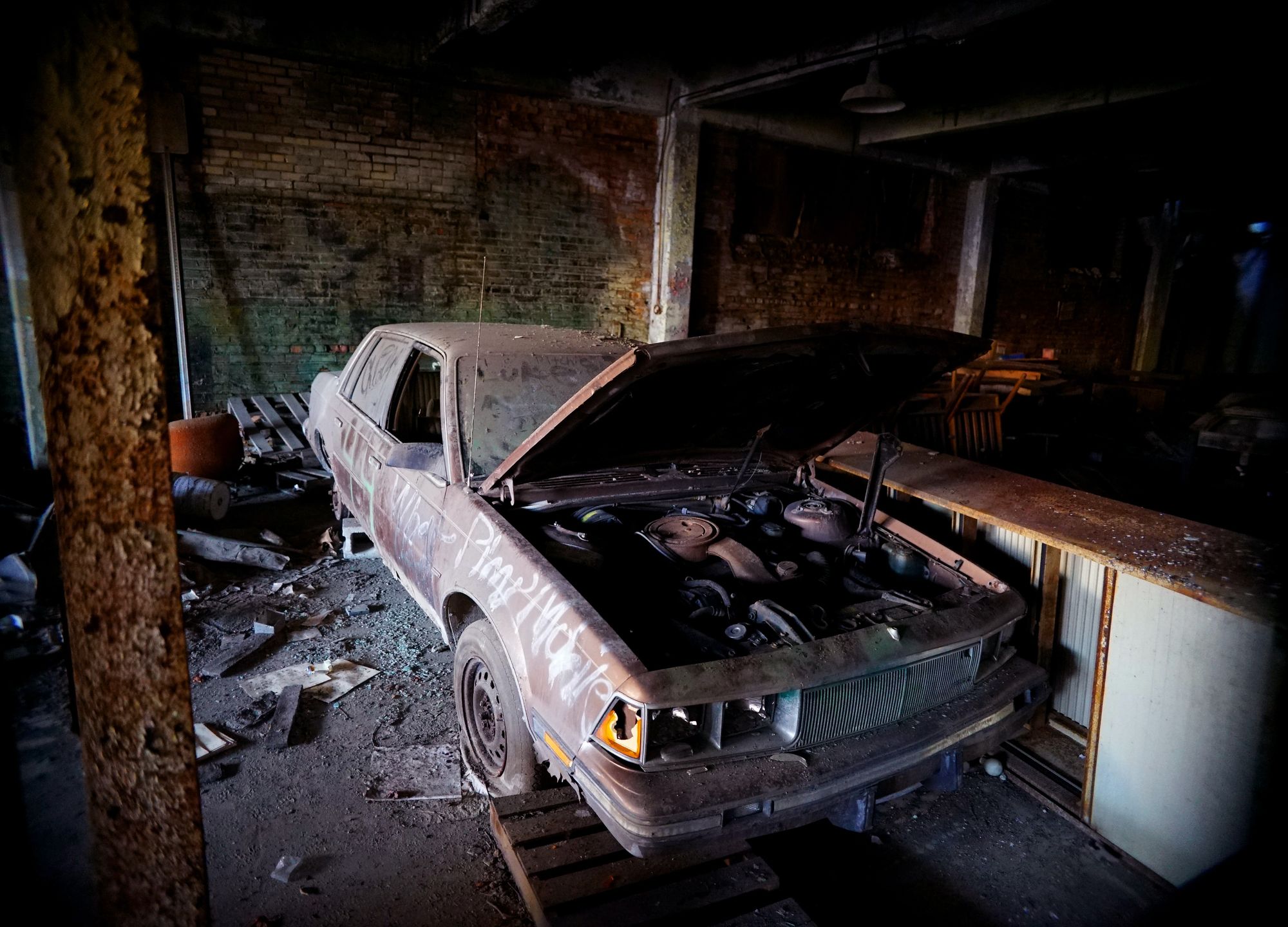 Old and rusty car with the hood open.