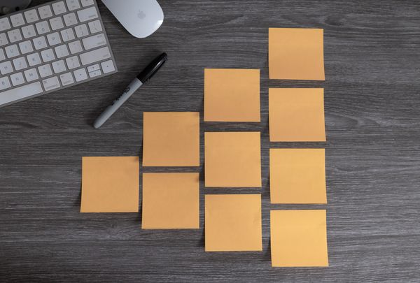 Number of perfectly-aligned sticky notes stuck on a table.