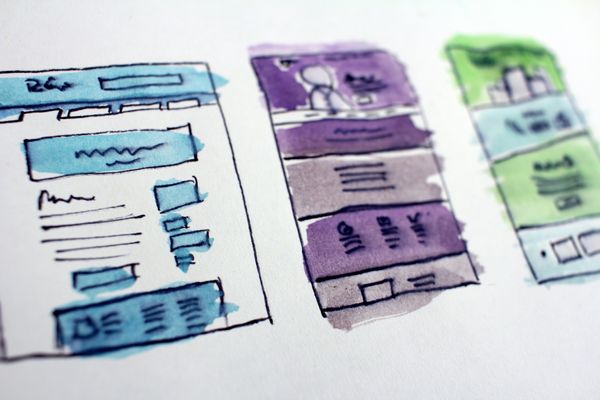 Three website mockups colored in water color.